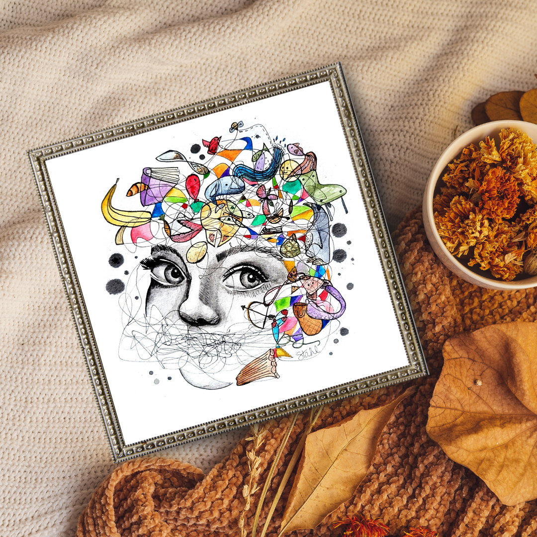A framed art print featuring a vibrant, abstract design with a central face surrounded by colorful elements, displayed on a wall.