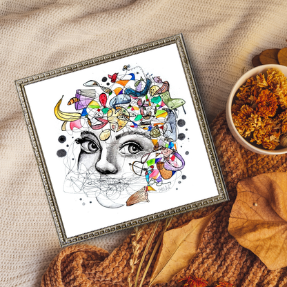 A framed art print featuring a vibrant, abstract design with a central face surrounded by colorful elements, displayed on a wall.