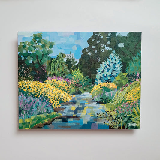 Painting of a garden scene with flowers and trees on a white wall